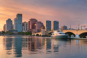 west palm beach, florida, usa. cityscape image of west palm beach, florida with reflection of the city skyline in the water at beautiful sunset.